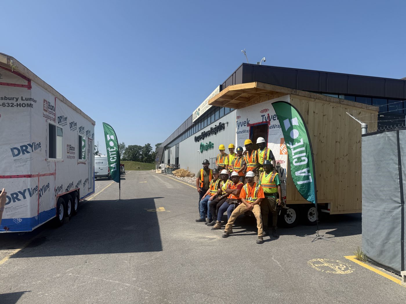 Collège La Cité students in front of the tiny homes they built
