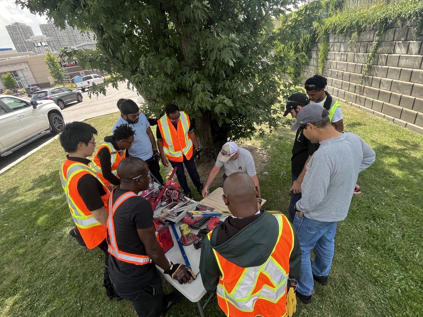 Participants gathered around the tool station